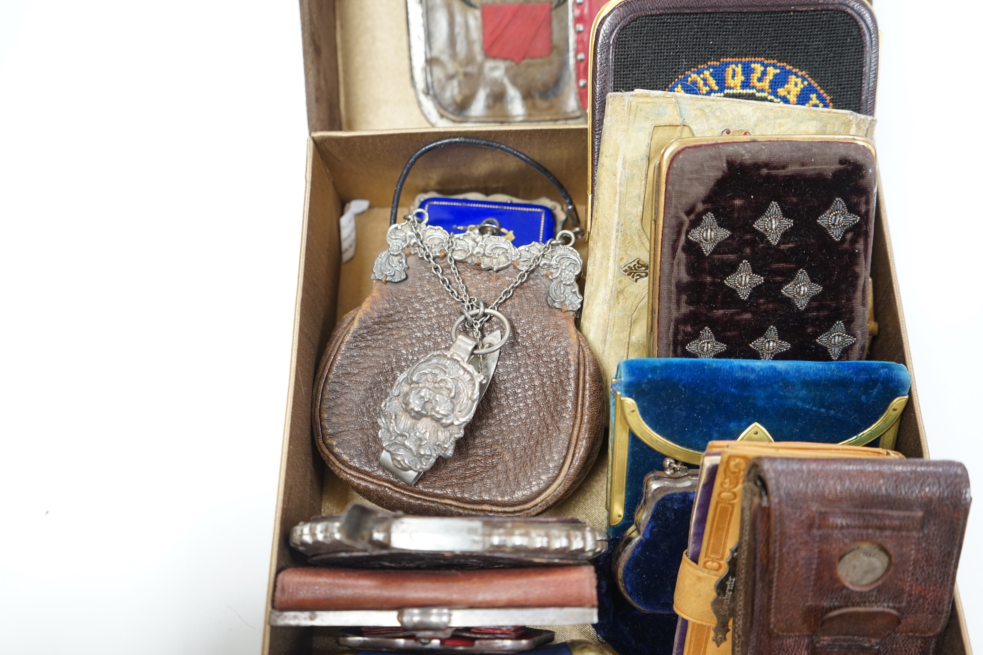 A collection of early 19th century and later embroidered, petite point, leather cut steel and velvet purses card cases etc